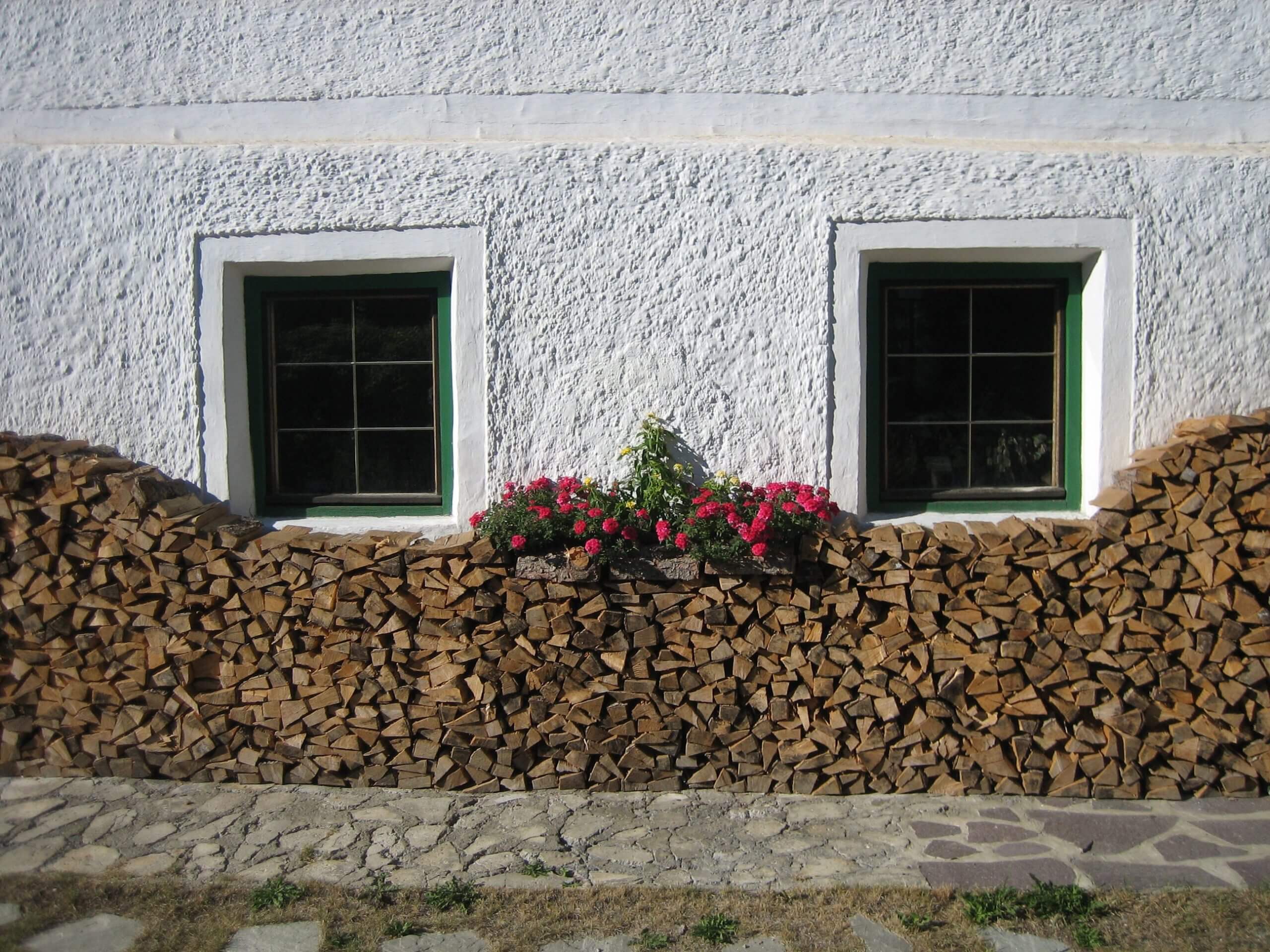 2 green windows in a white wall