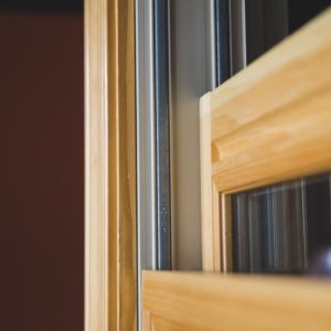A close up of a double hung window with a wooden frame.