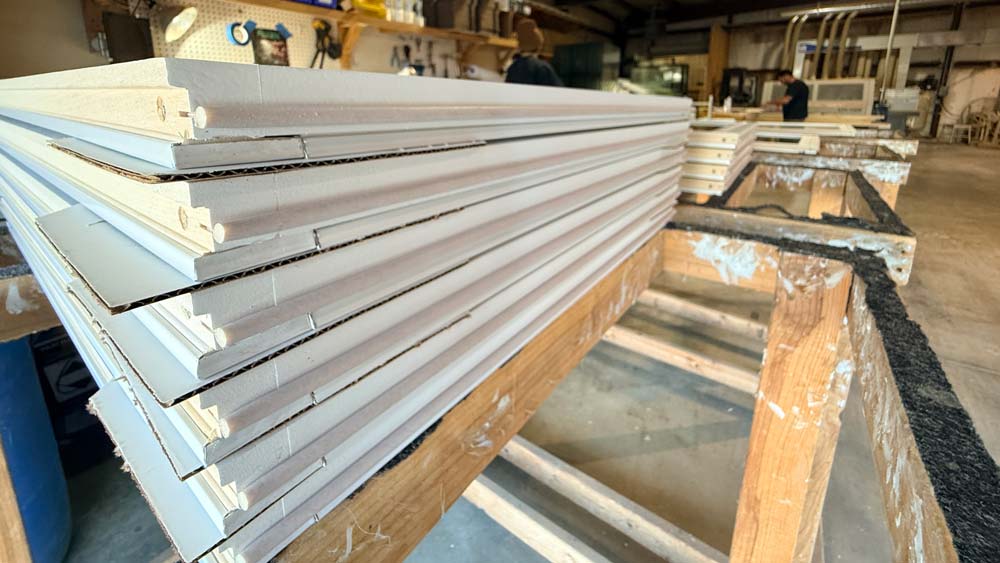 Stacks of double-hung-sashes being assembled.